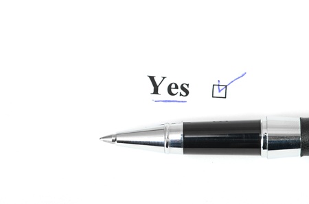 yes and pen isolated on a white backgroundの写真素材