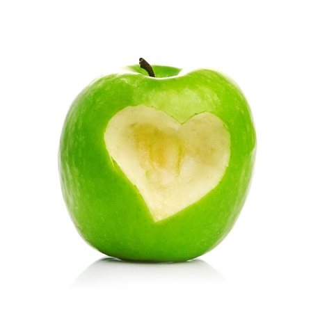 Fresh green apple with cut off heart shape.の写真素材