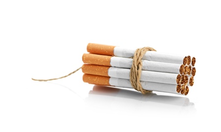 Cigarettes tied with rope and wick isolated on whiteの写真素材