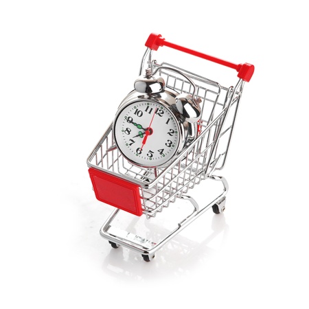 Buying time concept with clock and shopping cartの写真素材