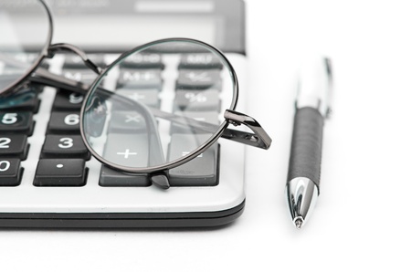 glasses and pen on calculatorの写真素材