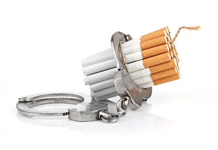 Addition concept with cigarettes and handcuffsの写真素材
