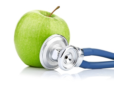 Medical stethoscope and apple isolated on whiteの写真素材
