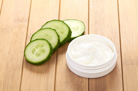 face mask with cucumber slices, white wood backgroundの写真素材