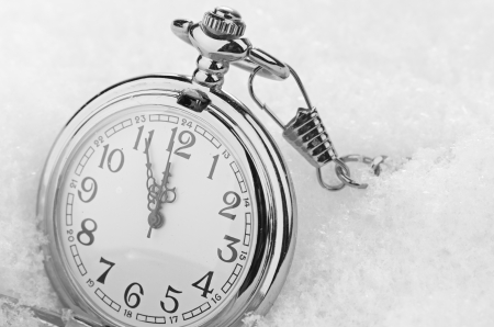 Watch lying in the snow before the new yearの写真素材