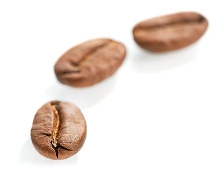 Macro of coffee beans isolated on white backgroundの写真素材