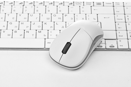 White computer mouse on the keyboardの写真素材