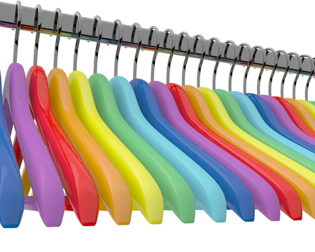 Row of color rainbow coat hangers on metal shiny clothes rail isolated on white の写真素材