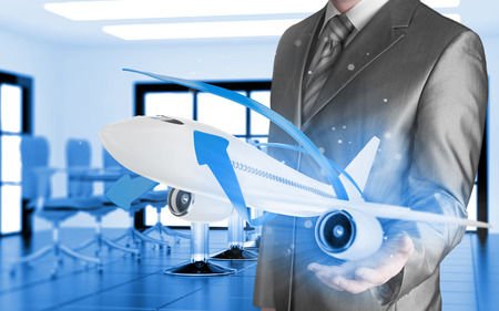 Businessman with airplane over his handの写真素材