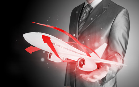 Businessman with airplane over his handの写真素材