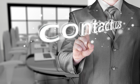 Businessman pushing CONTACT US signの写真素材