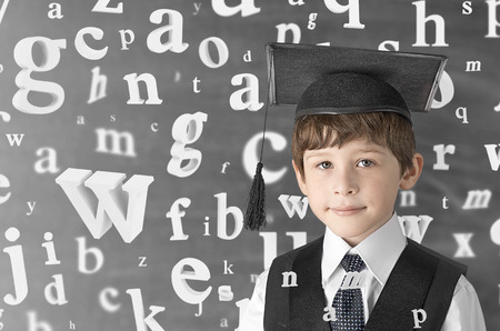 smart boy with flying letters, studio shotの写真素材
