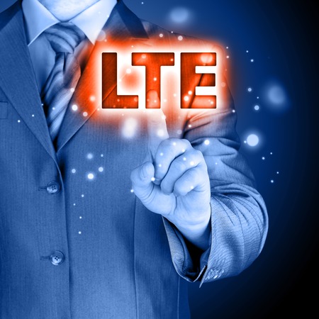 businessman is pushing his finger on lte buttonの写真素材
