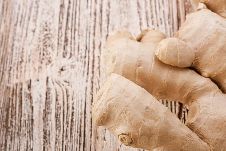 Ginger root sliced on wooden table