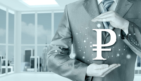 businessman protecting ruble  symbolの写真素材
