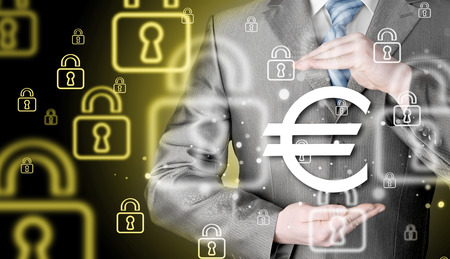 businessman protecting euro symbolの写真素材