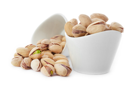 Heap of pistachios nuts isolated on the whiteの写真素材