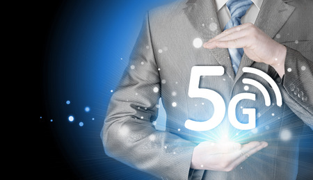 businessman holding in hand 5G symbol