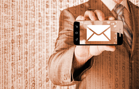 A man holding smartphone with one new message on a screenの写真素材