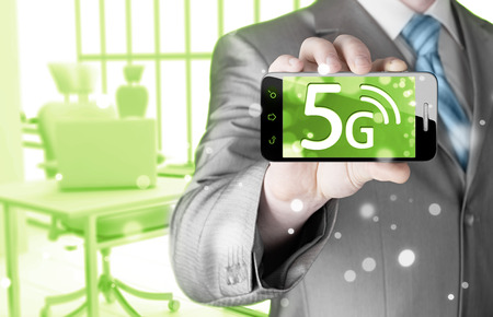 businessman holding in hand 5G, technology backgroundの写真素材