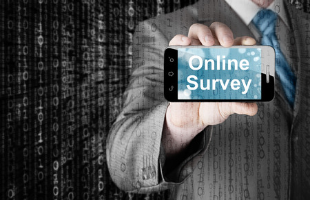 Businessman showing business concept on smartphone  - Online Surveyの写真素材