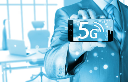 businessman holding in hand 5G, technology backgroundの写真素材