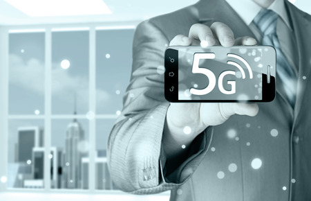 businessman holding in hand 5G, technology backgroundの写真素材