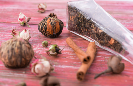 dry tea leaves cinnamon and on wooden background