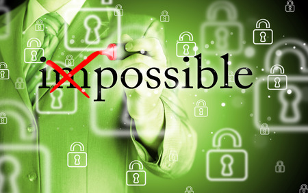 Businessman Hand turning the word Impossible into Possible with red marker
