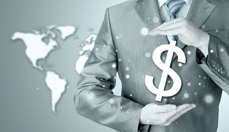 businessman protecting dollar symbolの写真素材