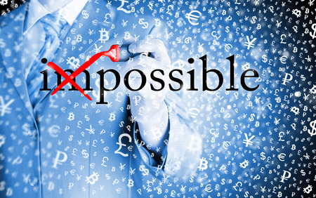 Businessman Hand turning the word Impossible into Possible with red markerの写真素材