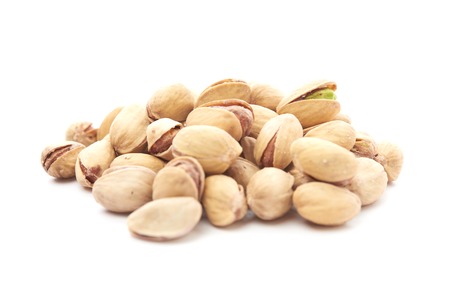 Heap of pistachios nuts isolated on the whiteの写真素材