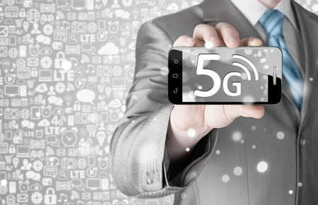 businessman holding in hand 5G, technology backgroundの写真素材