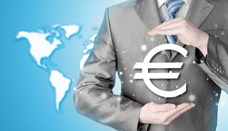 businessman protecting euro symbolの写真素材