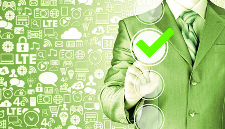 business man touching, pressing modern button with green ticking Check Box.の写真素材