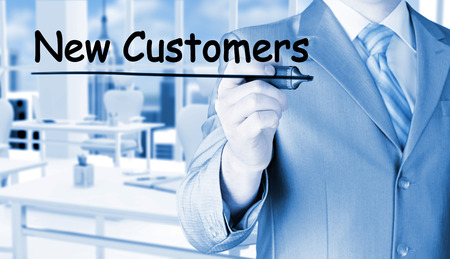 businessman writing new customersの写真素材