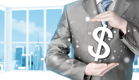 businessman protecting dollar symbolの写真素材