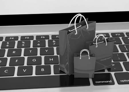 laptop and shopping bags on white backgroundの写真素材