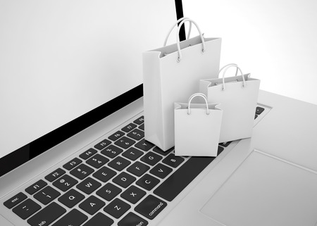 laptop and shopping bags on white backgroundの写真素材