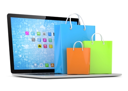 laptop and  shopping pags on white backgroundの写真素材