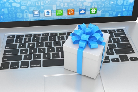 Gift box with ribbon on laptop keyboardの写真素材
