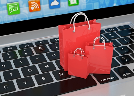 laptop and  shopping pags on white backgroundの写真素材