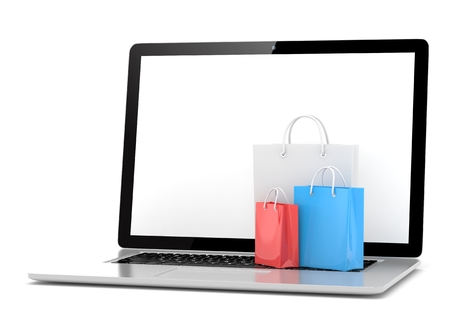laptop and  shopping pags on white backgroundの写真素材