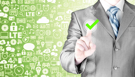 business man touching, pressing modern button with green ticking Check Box.の写真素材