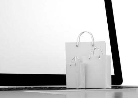 laptop and shopping bags on white backgroundの写真素材