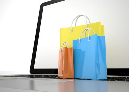 laptop and shopping bags on white background. 3d rendering.の写真素材