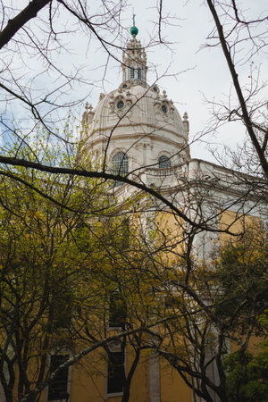 a view of a grand church with Baroque architectural elements, located in a city square. The facade...