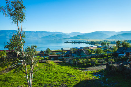 view on a Russian Siberian village on the coast of the Baikal lake by sunny summer dayの写真素材