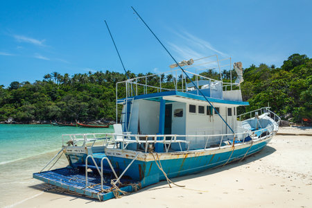 a fishing boat during a low tide on a shoal in a bay of the Koh Racha Yai island in Thailand at the Phuketの写真素材