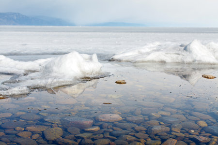 a thawed patch on the Baikal lake shore in spring